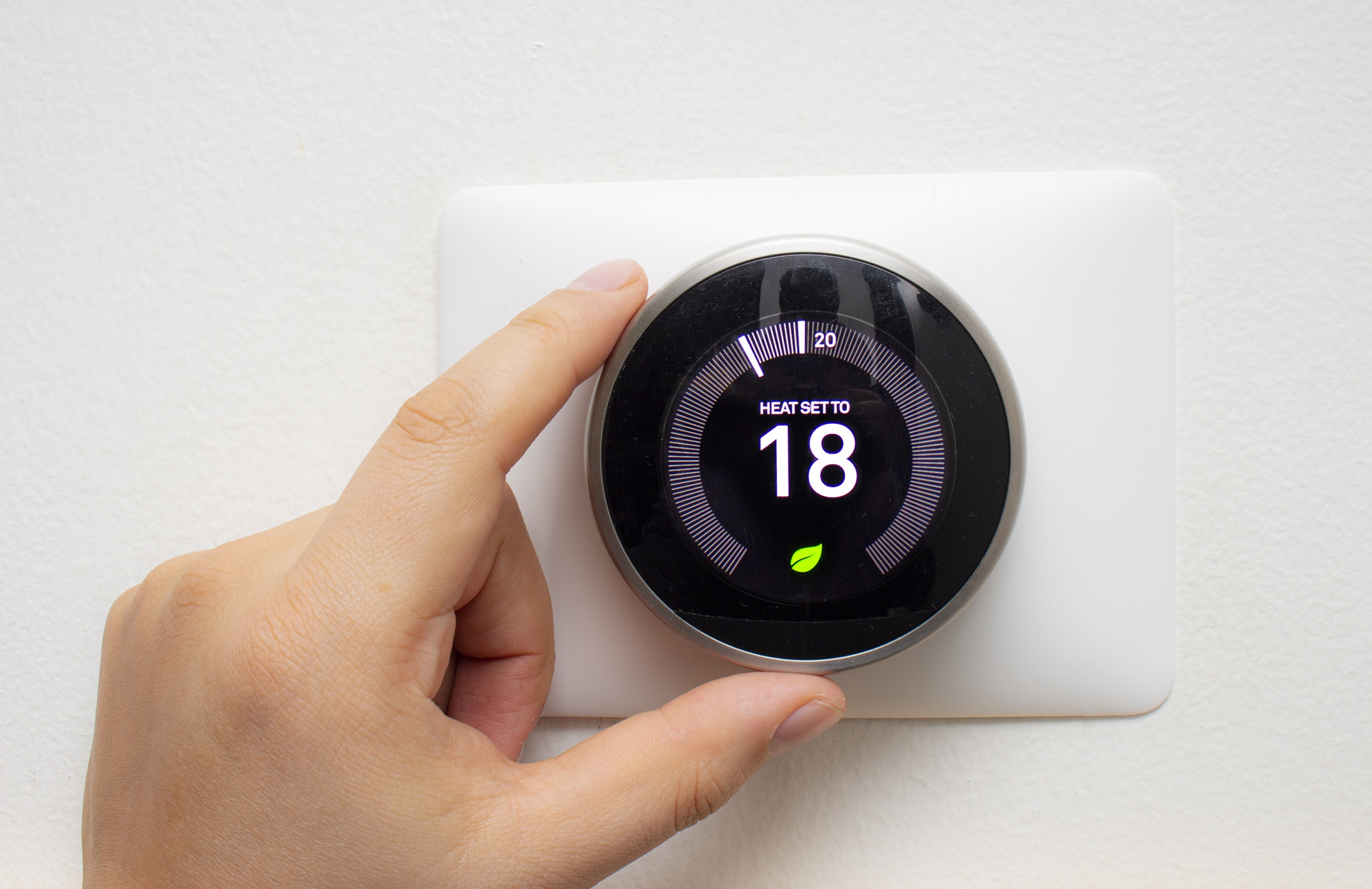 Smart Thermostat with a person saving energy with a soft shadow